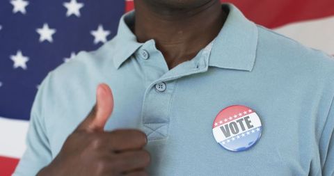 Proud Voter Against American Flag with Thumbs Up