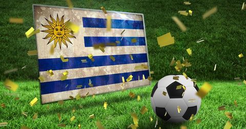Uruguay Flag and Soccer on Green Field with Confetti