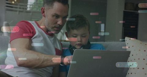 Father guiding son on laptop with digital data overlays, home learning and tech bonding