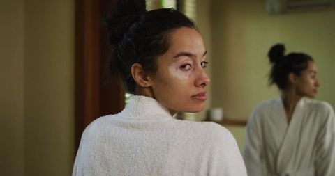 Woman with Vitiligo in Robe Reflecting in Mirror, Celebrating Natural Beauty
