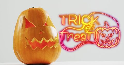 Halloween Jack-O'-Lantern with Neon Trick or Treat Sign - Download Free Stock Images Pikwizard.com