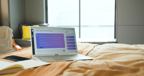 Cozy Home Workspace with Laptop and Marketing Plan