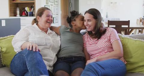 Happy Family Moment: Caucasian Lesbian Couple with Daughter Sharing Sofa - Download Free Stock Images Pikwizard.com
