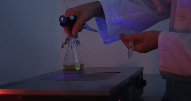 Scientist Conducting Laboratory Experiment with Fluorescent Liquid - Download Free Stock Images Pikwizard.com