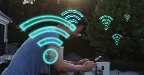 Asian man using tablet on rooftop terrace smiling while connecting to wifi networks