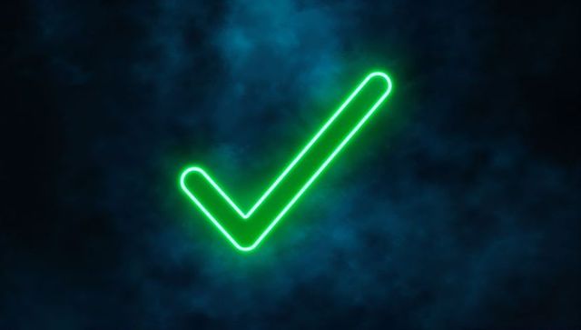Glowing neon green check mark on smoky blue background