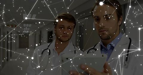 Doctors Analyzing Data with Digital Network Overlay in Hospital Setting
