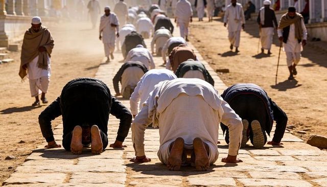 Sunlit pilgrims prostrating on stone pathway under dusty colonnade in traditional robes