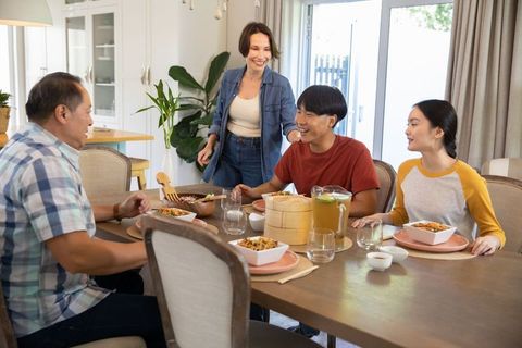 Asian Family Sharing Meal in Cozy Home Environment