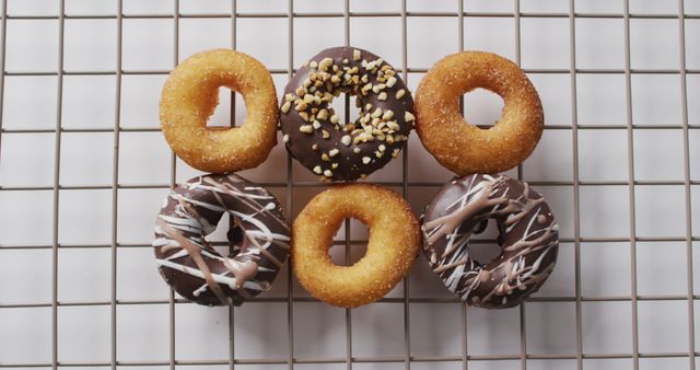 Assorted Donuts on Cooling Rack with Toppings and Glaze Patterns - Download Free Stock Images Pikwizard.com