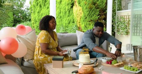 Couple Enjoying Birthday Celebration on Outdoor Patio