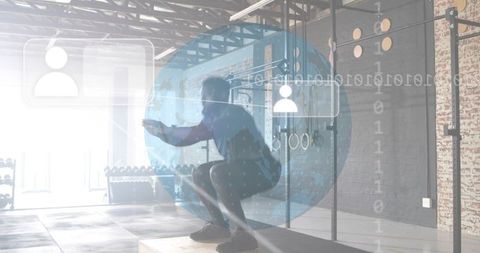 Male athlete squatting on plyo box with digital overlay in industrial gym