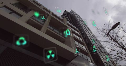 High-rise facade displaying holographic green eco icons for smart city sustainability