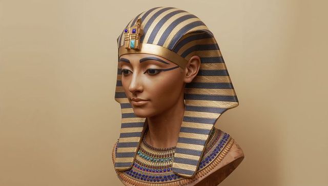 Pharaoh bust wearing nemes headdress with gemstone headband