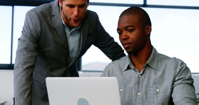 Two Businessmen Working Together on Laptop in Office - Download Free Stock Images Pikwizard.com