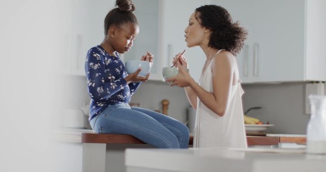 Mother and Daughter Eating Breakfast Together in Kitchen - Download Free Stock Images Pikwizard.com