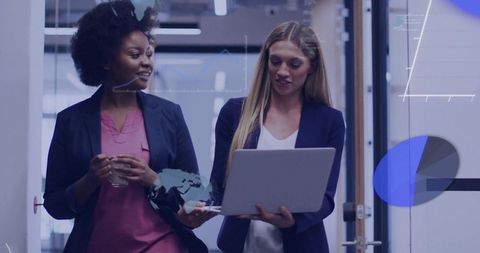 Businesswomen Collaborating with Digital Charts in Modern Office