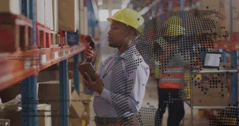 Warehouse inventory clerk scanning stock using tablet and handheld barcode scanner