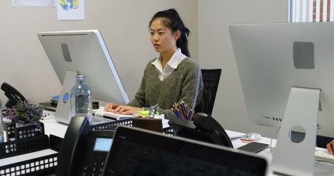 Dedicated Young Professional at Desk in Modern Office