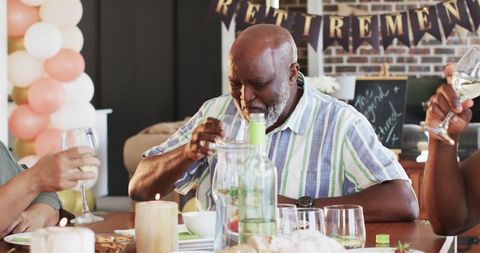 Senior Celebrating Retirement with Family Gathering in Living Room