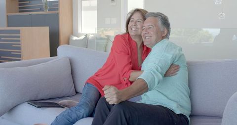 Senior Couple Enjoying Relaxed Moment on Cozy Sofa