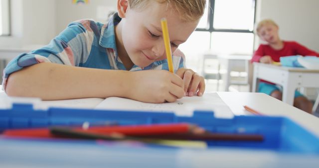 Young Boy Concentrating on Homework at Classroom Desk - Download Free Stock Images Pikwizard.com