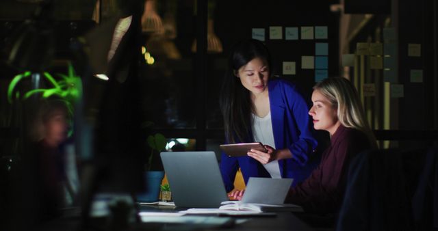 Two Businesswomen Working Late at Office with Technology - Download Free Stock Images Pikwizard.com