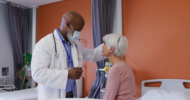 A doctor wearing a mask and lab coat is comforting a senior patient in a hospital room. Ideal for healthcare websites, elderly care services, patient support materials, and medical articles emphasizing compassionate care and trust between patient and medical professional.