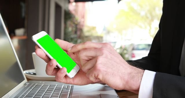 Businessman using smartphone with green screen in outdoor cafe - Download Free Stock Images Pikwizard.com