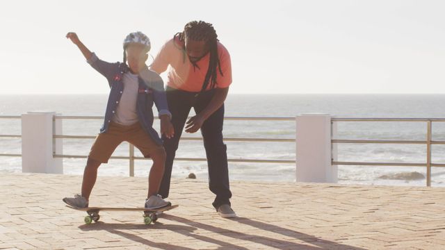 Father guiding son on understanding skateboard, creating a moment of bonding and learning demonstrates outdoor activities importance in childhood and family life. Useful for ads focusing on family unity, active lifestyle, hobbies.