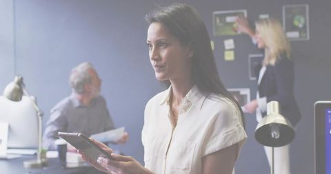 Woman Leading Team Planning with Tablet in Modern Collaborative Office