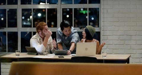 Diverse Team Collaborating Late Night in Modern Office