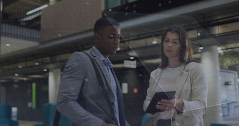 Business Colleagues Reviewing Plans in Modern Transit Hub