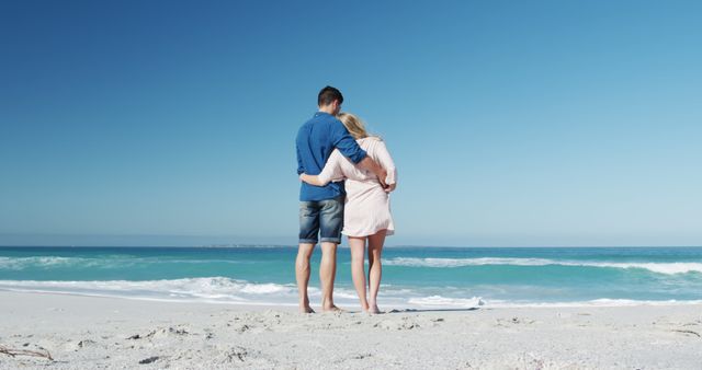 Romantic couple admiring ocean view on sunny beach - Download Free Stock Images Pikwizard.com