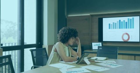 Businesswoman analyzing data in modern boardroom workshop