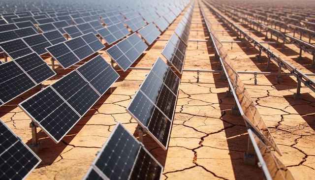 Expansive Solar Farm on Cracked Desert Soil with Reflective Photovoltaic Arrays
