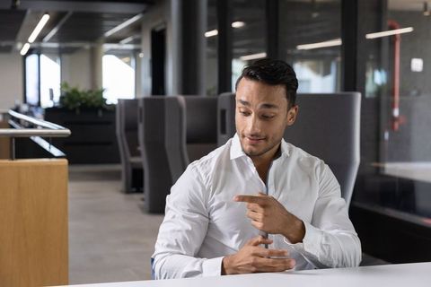 Confident Professional Discussing Ideas in Modern Office Lounge