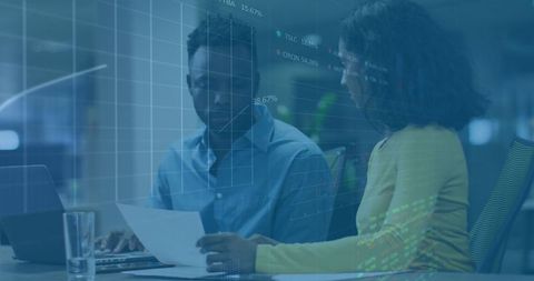 Colleagues Analyzing Data and Engaging in Discussion at Workplace