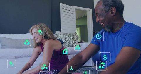 Mature couple exercising at home practicing seated forward stretch with eco wellness icons