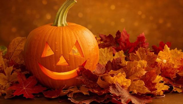 Glowing jack-o'-lantern with autumn leaves celebrating halloween