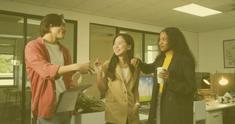 Diverse Colleagues Discussing Innovation in Open-Plan Office