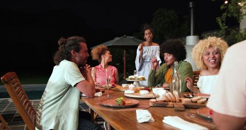 Diverse Group Enjoying Evening Dinner Party Outdoors