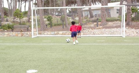 Boys Practicing Soccer Skills on Artificial Turf Field