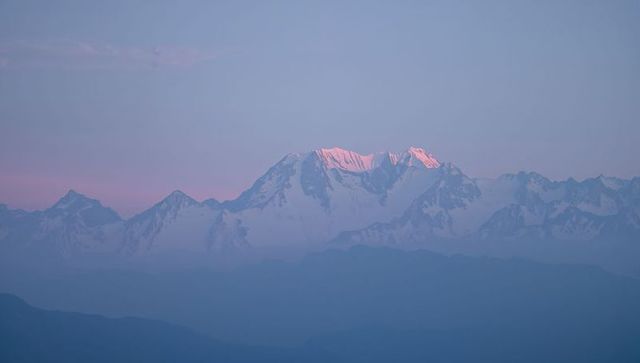 Pink Alpenglow Illuminating Snow-Capped Mountain Summit at Alpine Dawn, Pastel Panorama