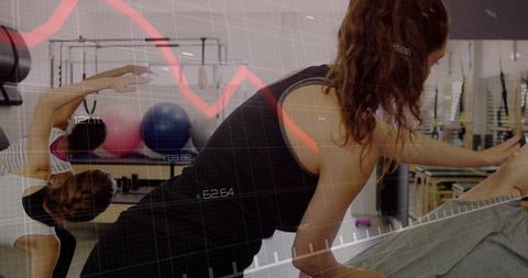 Pilates enthusiast reaching and stretching in studio