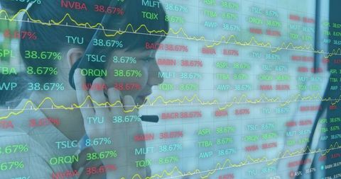 Finance professional analyzing stock ticker and data on screen