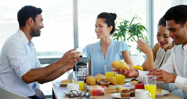 Happy Mixed Ethnicity Colleagues Enjoying Breakfast Together - Download Free Stock Images Pikwizard.com