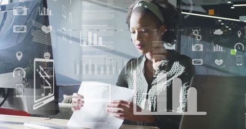 Focused Professional Analyzing Financial Reports with Digital Display