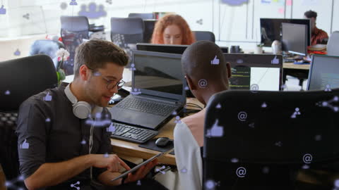 Creative Collaboration Amidst Digital Network Icons in Modern Office