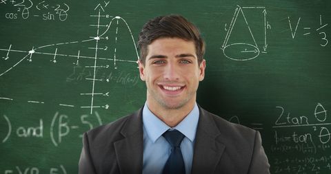 Smiling Male Educator Standing Before Chalkboard - Download Free Stock Images Pikwizard.com